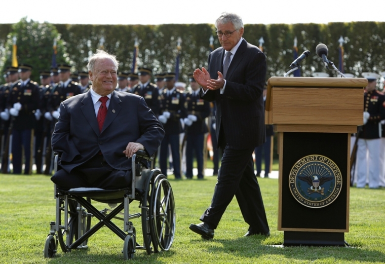 U.S. Secretary of Defense Chuck Hagel (R) applauds fellow Vietnam veteran and former U.S. Senator Max Cleland, D-Ga., while attending ceremonies marking the 2014 National POW/MIA Recognition Day at the Pentagon in Washington, September 19, 2014. Cleland lost both legs and his right forearm during service as an U.S. Army Captain in Vietnam.