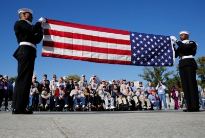 A U.S. Navy Honor Guard flag folding ceremony is watched by 22 U.S. military World War II veterans from St. Louis, Missouri visiting the National World War II Memorial on Veteran's Day in Washington, November 11, 2014.