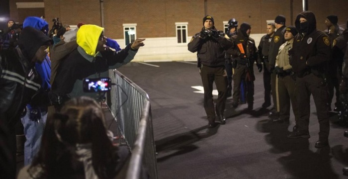 As the nation awaits a grand jury decision in the case of Michael Brown and police officer Darren Wilson, columnist and pastor Shane Idleman asks, 'What if?' Above photo: According to Reuters, protesters shout towards police as they demand the criminal indictment of a white police officer who shot dead an unarmed black teenager in August, outside the Ferguson Police Station in Missouri, Nov. 20, 2014.