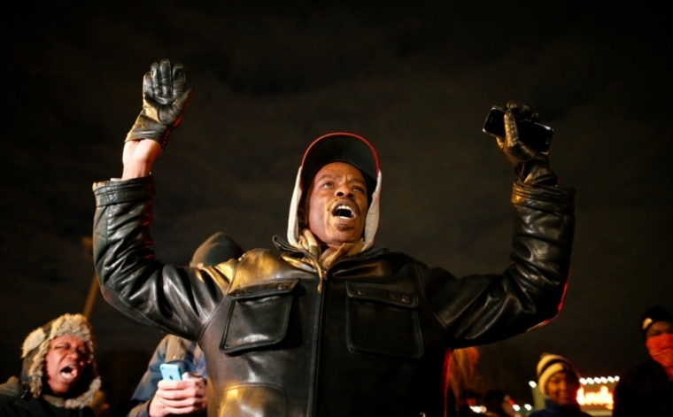 A protester holds his hands in the air outside the Ferguson Police Department in Ferguson, Missouri, November 24, 2014. A Missouri grand jury has made a decision on whether to indict a white police officer in the fatal shooting of an unarmed black teenager in Ferguson, a killing that sparked angry protests in the St. Louis suburb, the Washington Post reported on Monday.