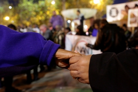 People hold hands while praying during a demonstration in Los Angeles, California, following the grand jury decision in the shooting of Michael Brown in Ferguson, Missouri, November 24, 2014. The grand jury found there was no probable cause to charge Ferguson, Missouri, police officer Darren Wilson with any crime for the shooting of 18-year-old Brown.