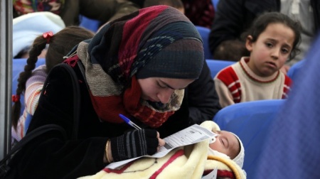 A Syrian refugee fills out an application at a U.N. center in Lebanon, (FILE).