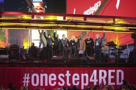 Singers (L-R) The Edge, Larry Mullen, Bruce Springsteen, Carrie Underwood, Kanye West, Chris Martin and Adam Clayton wave to the crowd after their surprise concert in support of World AIDS Day in Times Square in New York, December 1, 2014