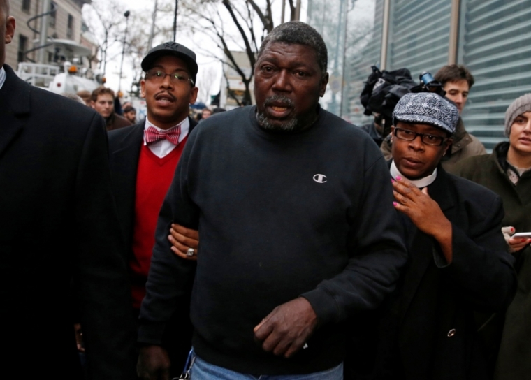 Benjamin Carr (C), stepfather of Eric Garner, leaves the Staten Island prosecutors office in the Staten Island borough of New York, December 3, 2014. A New York grand jury has decided not to charge police officer Daniel Pantaleo, who killed an unarmed black man, Garner, with a chokehold while trying to arrest him for illegally selling cigarettes, a lawyer for the victim's family said on Wednesday.