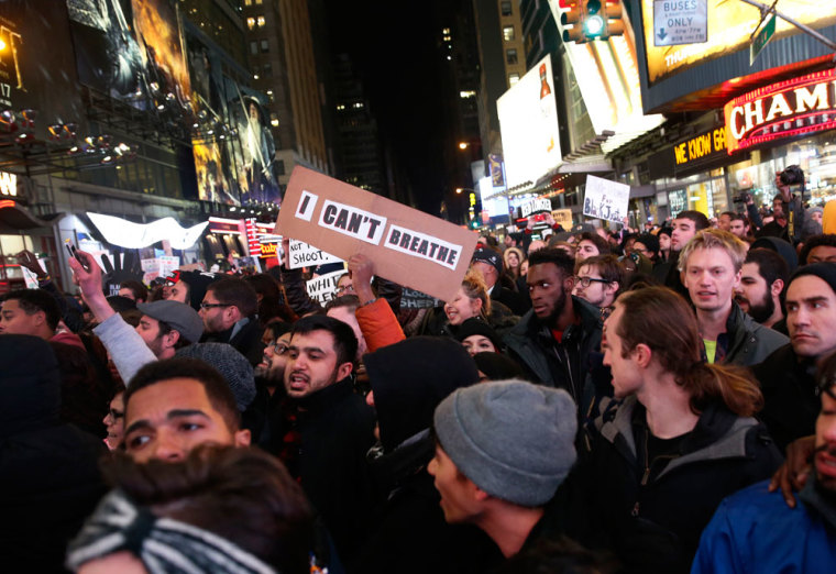 Demonstrators fill 7th Avenue in Times Square as they protest a grand jury decision not to charge a New York policeman in the choking death of Eric Garner, in New York December 4, 2014. U.S. Attorney General Eric Holder on Thursday promised a full investigation into a white New York police officer's role in the choking death of Garner, following a night of protests over a grand jury decision not to bring charges in the incident.