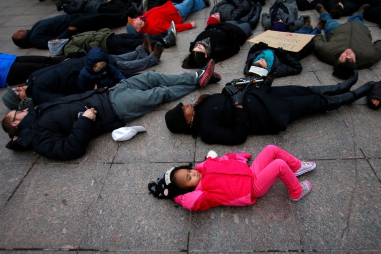 demanding justice for Eric Garner, as they stage a 'die-in' in downtown White Plains, New York, December 5, 2014.