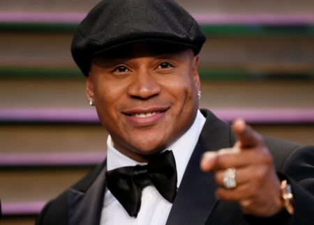 Rapper LL Cool J gestures upon arriving at the 2014 Vanity Fair Oscars Party in West Hollywood, California, March 2, 2014.