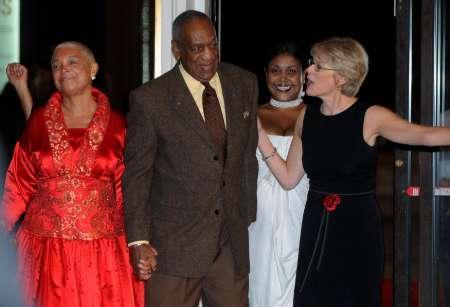 Comedian, actor, author and musician Bill Cosby (C) holds hands with his wife Camille as he is shown the way to the red carpet at the Kennedy Center For the Performing Arts, where he is being feted as this year's winner of the Mark Twain Prize for American Humor, in Washington, October 26, 2009.