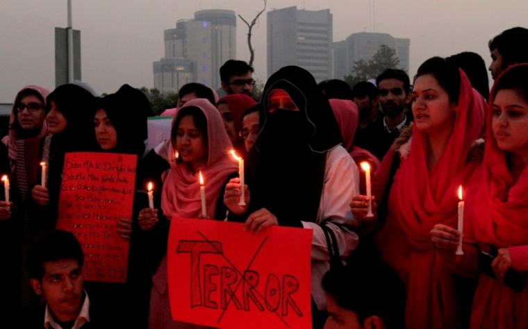 People hold placards and candles in memory of victims of the Taliban attack on the Army Public School, during a rally in Islamabad, December 17, 2014. At least 132 students and nine staff members were killed on Tuesday when Taliban gunmen broke into the school and opened fire, witnesses said, in the bloodiest massacre the country has seen for years.