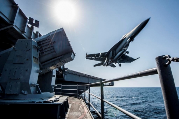 A U.S. Navy F/A-18 launches from the USS Carl Vinson in this undated handout picture released November 1, 2014. U.S.-led air strikes hit Islamic State positions around Kobani earlier in the day in an apparent effort to pave the way for the heavily-armed Kurdish contingent to enter.