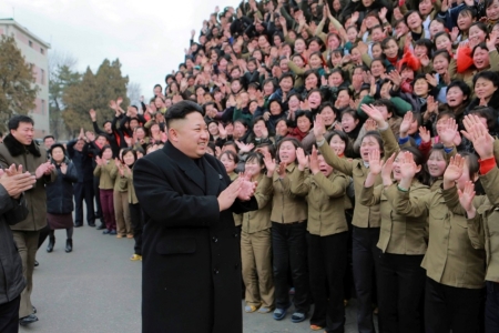 North Korean leader Kim Jong Un (C) smiles as he gives field guidance at the Kim Jong Suk Pyongyang Textile Mill in this undated photo released by North Korea's Korean Central News Agency in Pyongyang, December 20, 2014.