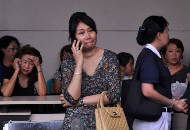 Family members of passengers on board AirAsia flight QZ8501 wait for information inside the AirAsia crisis centre at Juanda Airport in Surabaya, East Java December 28, 2014 in this photo taken by Antara Foto. Indonesia called off until first light a search for an AirAsia plane with 162 people on board that went missing on Sunday after pilots asked to change course to avoid bad weather during a flight from Indonesia's Surabaya city to Singapore. Indonesia AirAsia Flight QZ8501, an Airbus 320-200 carrying 155 passengers and seven crew, lost contact with Jakarta air traffic control at 6:17 a.m. (2317 GMT on Saturday). No distress signal had been sent, said Joko Muryo Atmodjo, an Indonesian transport ministry official.