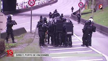 Authorities surround a grocery store in Paris, where people have been taken hostage on Jan. 9, 2015.