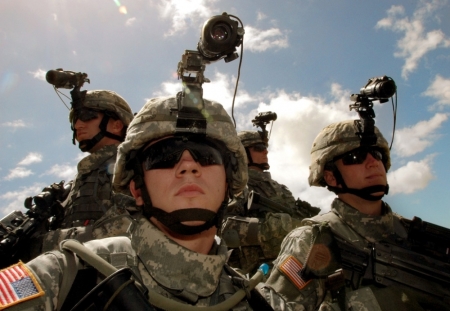 Specialist Jonathan Hurd (2nd L), of Falkville, Arkansas, Private Brian Foster (R) of Chicago, Illinois, Sergeant Raymond Shawn (L) of Los Angeles, California, and Specialist George Greenwell (2nd R) of Evansville, Indiana, display their respective rifles, machine guns and grenade launchers while wearing night vision goggles during a deployment ceremony at Schofield Barracks, near Wahiawa, Hawaii, July 7, 2006. About 7,000 troops from Schofield will be leaving Hawaii in the next few weeks and will be deployed to Iraq. This continues the largest deployment of Hawaii-based troops since the Vietnam War.