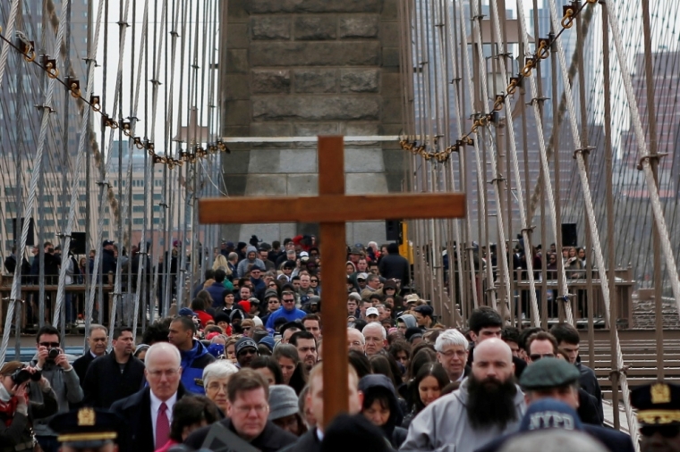 People participate in the 19th annual 'Way of the Cross Over the Brooklyn Bridge Ceremony' in New York City April 18, 2014. The ceremony, hosted yearly on the Christian holy day of Good Friday, includes walking from St. James Cathedral, over the Brooklyn Bridge to St. Peter's Church in Manhattan. The event attracts approximately 2,000 people each year.