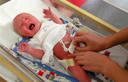 Newborn Alexander Rowland is examined by a paediatrician in the maternity ward at Hinchingbrooke Hospital in Huntingdon, eastern England, November 3, 2011. A private company called Circle will take over NHS hospital, Hinchingbrooke, in 2012 in a deal which will be the first of it's kind, local media reported. Photograph taken on November 3, 2011.