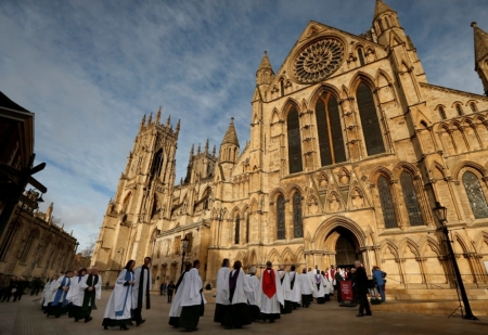 Members of the clergy enter York Minster before a service to consecrate Reverend Libby Lane as the first female bishop in the Church of England, in York, northern England, January 26, 2015.