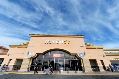 Customers walk outside a Walmart store in the Porter Ranch section of Los Angeles, California, November 26, 2013. This year, Black Friday starts earlier than ever, with some retailers, including Wal-Mart, opening early on Thanksgiving evening. About 140 million people were expected to shop over the four-day weekend, according to the National Retail Federation.