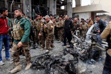 Members of the Kurdish security forces inspect the site of bomb attack in Kirkuk, Iraq, January 30, 2015. Islamic State militants struck at Kurdish forces southwest of the Iraqi city of Kirkuk on Friday morning, while bombs in Baghdad and Samarra killed at least 21 people, security and medical sources said. Police in the northern province of Kirkuk said Islamic State launched mortars and attacked positions of Kurdish peshmerga fighters in four districts southwest of Kirkuk city.