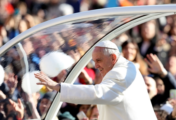 Pope Francis waves as he arrives to lead the general audience in St. Peter's square at the Vatican, Rome, Italy, February 11, 2015.