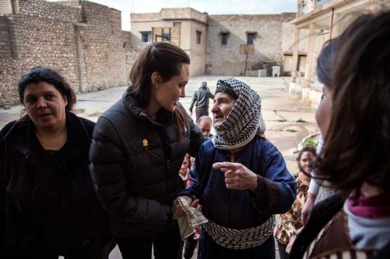 United Nations High Commissioner for Refugees Special Envoy Angelina Jolie (2nd L) meets displaced Iraqis who are members of the minority Christian community, living in an abandoned school in Al Qosh, northern Iraq, January 26, 2015.