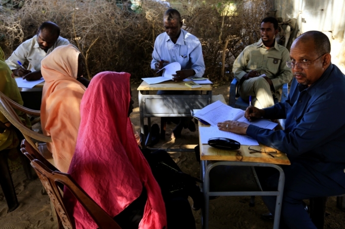 Special Prosecutor for Crimes in Darfur Yasir Ahmed Mohamed (R) and his team talk to women during an investigation into allegations of mass rape in the village of Tabit, in North Darfur, November 20, 2014. The joint peacekeeping mission known as UNAMID has been trying to gain access to visit Tabit since earlier this month to investigate media reports of an alleged mass rape of 200 women and girls in Tabit. Mohamed and his team began initial investigations into the allegations on Wednesday.