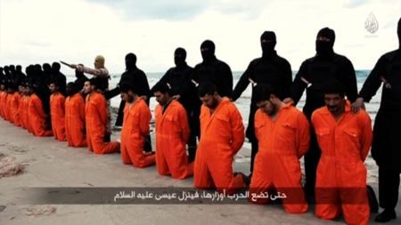 Men in orange jumpsuits purported to be Egyptian Christians held captive by the Islamic State kneel in front of armed men along a beach said to be near Tripoli, in this still image from an undated video made available on social media on February 15, 2015. Islamic State released the video on Sunday showing the beheading of 21 Egyptian Christians kidnapped in Libya. In the video, militants in black marched the captives to a beach that the group said was near Tripoli. They were forced down onto their knees, then beheaded. Egypt's state news agency MENA quoted the spokesman for the Coptic Church as confirming that 21 Egyptian Christians believed to be held by Islamic State were dead.