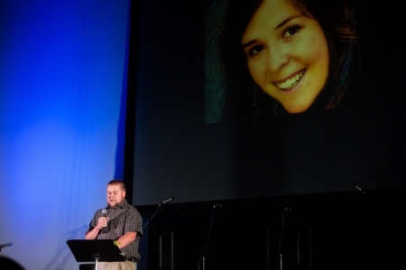 Eric Mueller reads a poem about his late sister aid worker Kayla Mueller at the Prescott's Courthouse Square in Prescott, Arizona, February 18, 2015. Friends and colleagues of Mueller, the aid worker who died while a captive of militants of the Islamic State group in Syria, remembered her on Saturday in a candlelight vigil as someone who was trying to give back in gratitude for a life of freedom. Mueller, 26, was confirmed to have died under circumstances that remain unclear about 18 months after she was abducted while leaving a hospital in northern Syria.