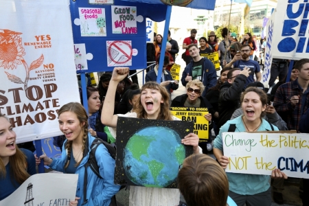 Protesters meet up in front of City Hall before an anti-fracking march and demonstration in Oakland, California, February 7, 2015. Thousands attended the march, urging Governor Jerry Brown to ban the controversial oil extraction procedure in the state.