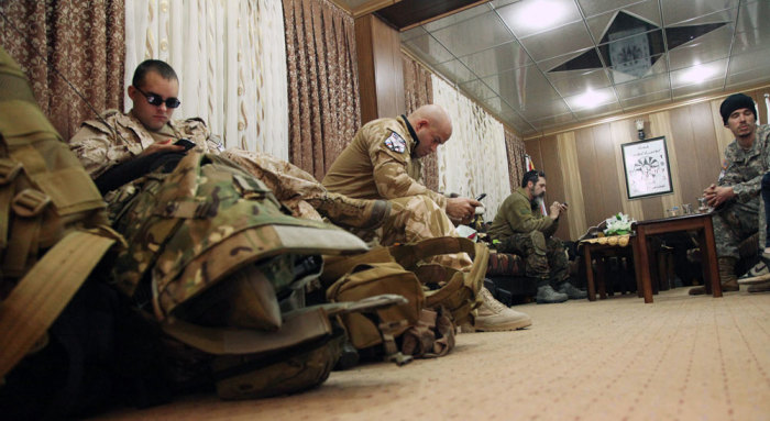 Westerners who have joined the Iraqi Christian militia Dwekh Nawsha to fight against Islamic State militants sit together at the office of the Assyrian political party in Dohuk, northern Iraq February 13, 2015. Thousands of foreigners have flocked to Iraq and Syria in the past two years, mostly to join Islamic State, but a handful of idealistic Westerners are enlisting as well, citing frustration their governments are not doing more to combat the ultra-radical Islamists or prevent the suffering of innocents. The militia they joined is called Dwekh Nawsha - meaning self-sacrifice in the ancient Aramaic language spoken by Christ and still used by Assyrian Christians, who consider themselves the indigenous people of Iraq. Picture taken February 13, 2015.