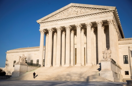 A police officer walks up the steps of the Supreme Court in Washington March 2, 2015.