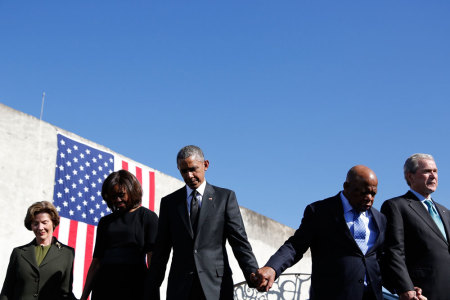 U.S. President Barack Obama and first lady Michelle Obama (2nd L) hold hands with former President George W Bush (R) and former first lady Laura Bush (L) and U.S. Rep. John Lewis (D-GA) during commemoration of the 50th anniversary of the 'Bloody Sunday' historical civil rights march at the Edmund Pettus Bridge in Selma, Alabama, March 7, 2015.