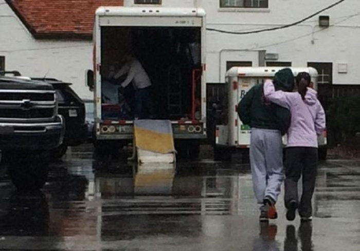 People load goods into moving trucks at the back of the Sigma Alpha Epsilon fraternity at the University of Oklahoma in Norman, Oklahoma, March 9, 2015.