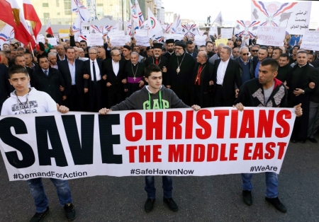 Assyrians hold banners as they march in solidarity with the Assyrians abducted by Islamic State fighters in Syria, in Beirut, Labanon, February 28, 2015. Militants in northeast Syria are now estimated to have abducted at least 220 Assyrian Christians this week, a group monitoring the war reported.