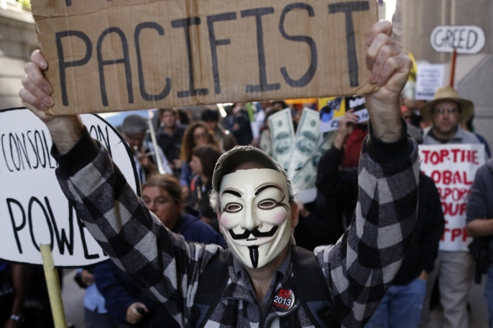 Occupy Wall Street protesters march down Wall Street by the New York Stock Exchange in New York's financial district September 17, 2013. The Occupy Wall Street movement celebrates thier second anniversary on September 17.