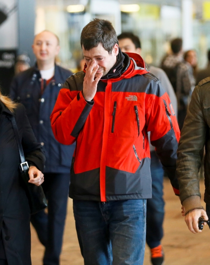 A family member of a passenger killed in Germanwings plane crash reacts as he arrives at Barcelona's El Prat airport March 24, 2015. An Airbus operated by Lufthansa's Germanwings budget airline crashed in a remote area of southern France on Tuesday and all 148 on board were feared dead.