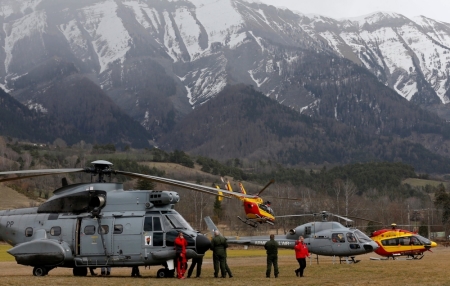 Rescue helicopters from the French Securite Civile and the Air Force are seen in front of the French Alps during a rescue operation near to the crash site of an Airbus A320, near Seyne-les-Alpes, March 24, 2015. An Airbus plane operated by Lufthansa's Germanwings budget airline, en route from Barcelona to Duesseldorf, crashed in a remote snowy area of the French Alps on Tuesday and all 150 on board were feared dead.