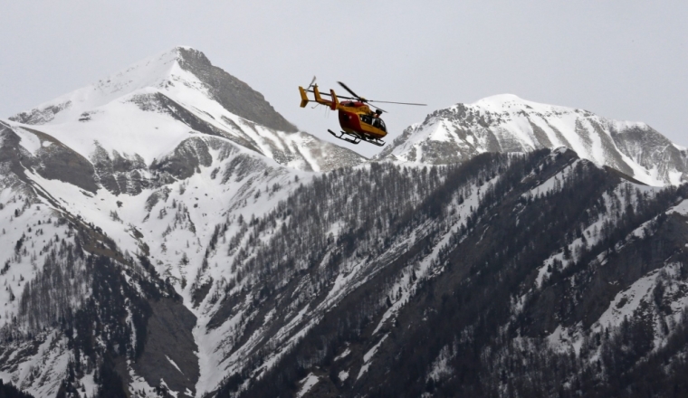 A rescue helicopter from the French Securite Civile flies over the French Alps during a rescue operation after the crash of an Airbus A320, near Seyne-les-Alpes, March 24, 2015. An Airbus plane operated by Lufthansa's Germanwings budget airline, en route from Barcelona to Duesseldorf, crashed in a remote snowy area of the French Alps on Tuesday and all 150 on board were feared dead.