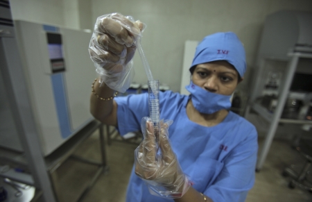 An embryologist carries-out a sample preparation process at Fortis Bloom Fertility and IVF Centre inside the Fortis hospital at Mohali in the northern Indian state of Punjab, June 13, 2013.