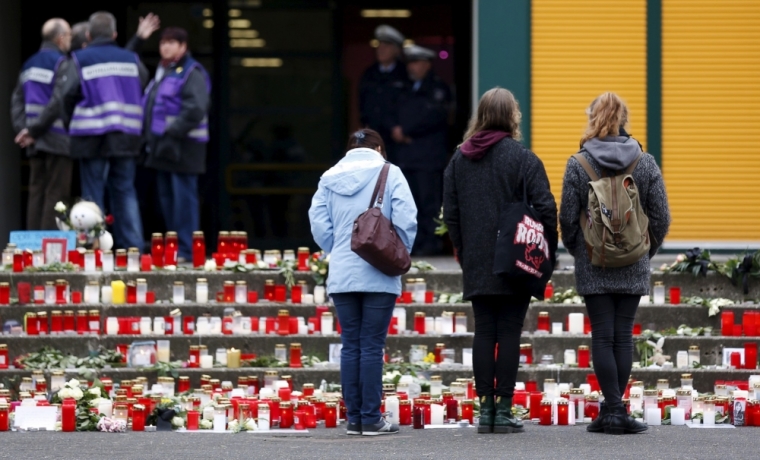 Students stand in front of the Joseph-Koenig-Gymnasium high school in Haltern am See, March, 26, 2015. The deaths of 16 teenage students and two young teachers in the Germanwings plane crash in the French Alps left the lakeside town of Haltern am See in a state of shock on Wednesday, with the German nation sharing in their mourning and grief. French investigators searched for clues as to why the German Airbus flying from Barcelona to Duesseldorf ploughed into an Alpine mountainside, killing all 150 on board, including 16 German students from the Joseph-Koenig-Gymnasium high school who were on a Spanish language exchange programme.