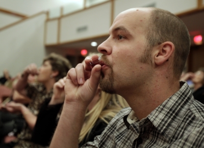 Jimi Nash drinks communion wine during a Sunday service at Bella Vista Assembly of God church in Bella Vista, Arkansas, November 8, 2009.