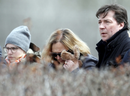 People identified by the the mayor of Le Vernet as family members of the pilot of the Germanwings Airbus A320 react as they pay their respects at the memorial for the victims of the air disaster in the village of Le Vernet, near the crash site of the Germanwings Airbus A320 in French Alps March 28, 2015. The co-pilot suspected of deliberately crashing a passenger plane in the French Alps told his girlfriend he was in psychiatric treatment, and that he was planning a spectacular gesture that everyone would remember, the German daily Bild reported on Saturday.