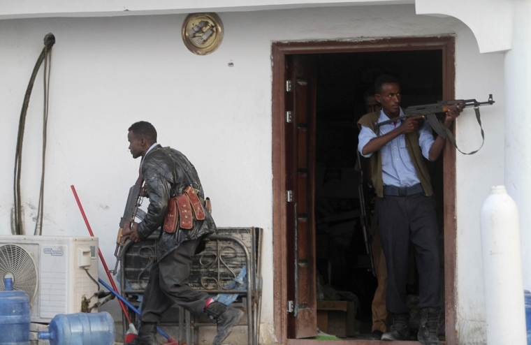 Somali police take position after Islamist group al Shabaab attacked Maka Al-Mukarama hotel in Mogadishu, March 27, 2015. Islamist militants blasted their way into a popular hotel in the Somali capital Mogadishu on Friday, killing at least seven people and trapping government officials inside, police and witnesses said.