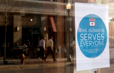 A sign reading 'This business serves everyone' is placed in the window of Bernadette's Barbershop in downtown Lafayette, Indiana, March 31, 2015. The store is one of several who display a sticker stating 'This business serves everyone.' Indiana's Republican Governor Mike Pence, responding to national outrage over the state's new Religious Freedom Restoration Act, said on Tuesday he will 'fix' it to make clear businesses cannot use the law to deny services to same-sex couples.