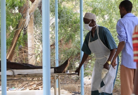 A morgue worker pulls the body of a suspected Garissa University College attacker in front of a morgue in Garissa, April 4, 2015. The death toll in an assault by Somali militants on Garissa University College is likely to climb above 147, a government source and media said on Friday, as anger grew among local residents over what they say as a government failure to prevent bloodshed.