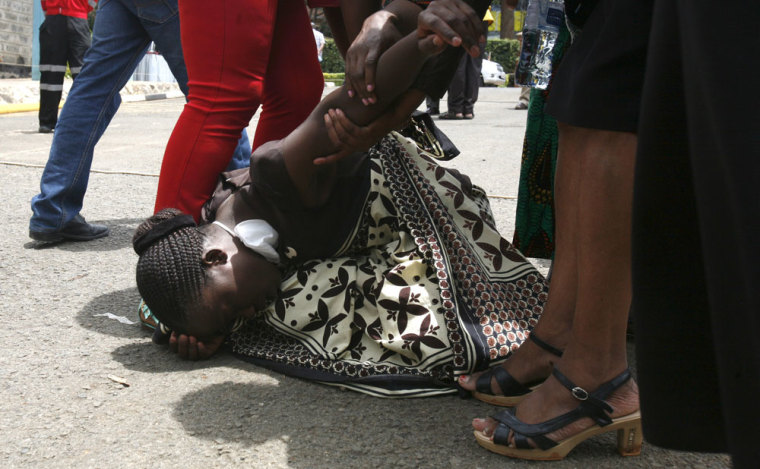 A relative is assisted by Kenya Red Cross staff as she reacts where bodies of the students killed in Thursday's attack by gunmen are preserved at the Chiromo Mortuary in the capital Nairobi April 5, 2015. The son of a Kenyan government official was one of the masked gunmen who killed nearly 150 people at a university last week, the interior ministry said on Sunday, as Kenyan churches hired armed guards to protect their Easter congregations.