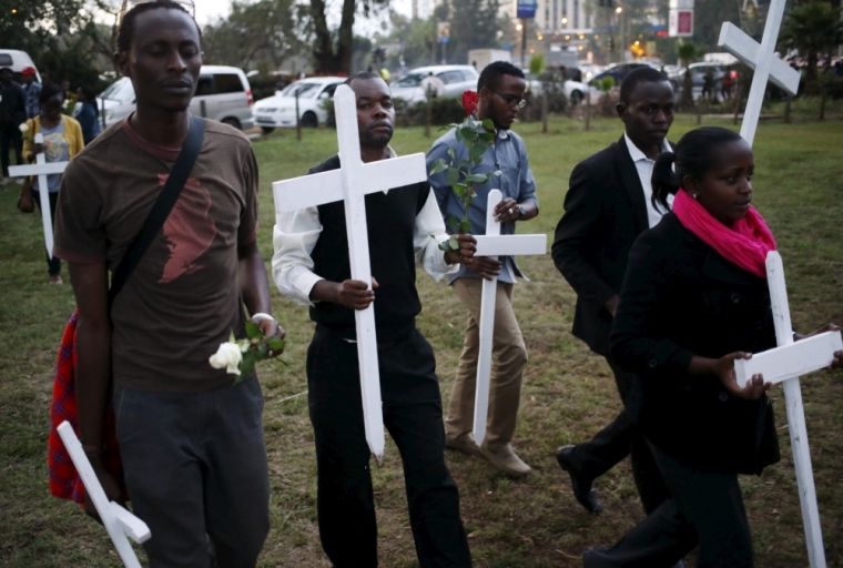 People carry wooden crosses, symbolizing the people killed by gunmen at the Garissa University College, during a memorial vigil at the 'Freedom Corner' in Kenya's capital Nairobi, April 7, 2015. Kenyan university students marched in the capital on Tuesday to demand more security from the government after gunmen killed nearly 150 people at a campus in the eastern town of Garissa last week. A citizens group planned to hold a vigil in Nairobi's main park later in the evening, tapping growing public frustration over security in the wake of the attack claimed by al-Shabaab radical Islamists based in neighboring Somalia.