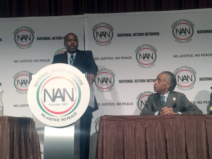 Renowned neurosurgeon and potential 2016 GOP presidential hopeful Dr. Ben Carson (podium) speaks at the National Action Network's annual convention in New York City on Wednesday, April 8, 2015, as the organization's founder, the Rev. Al Sharpton listens intently.