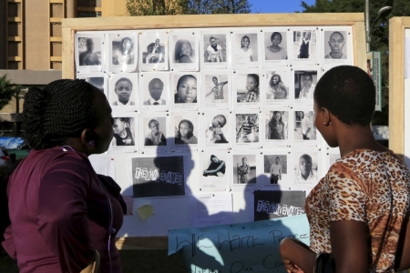 People look a board displaying the pictures of some of the students who were killed by gunmen at Garissa University College, as Kenyans continue to pay their respects at the 'Freedom Corner' in Kenya's capital Nairobi, April 9, 2015.