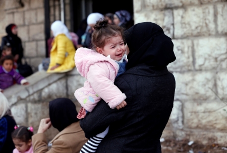 Palestinian women, who had been living at Yarmouk Palestinian refugee camp in Syria, wait outside the Lebanese immigration authority to have their papers stamped at the Lebanese-Syrian border, in al-Masnaa, December 18, 2012. More than 1,000 Palestinian refugees living in Syria have crossed into Lebanon in the past 24 hours, a source at the Lebanese border said on Tuesday, after Syrian rebels took control of a Palestinian refugee camp in Damascus.